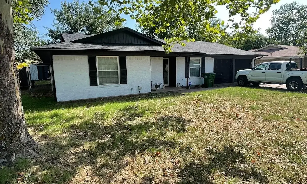 Professional roofing crew working on a residential roof in Rochelle